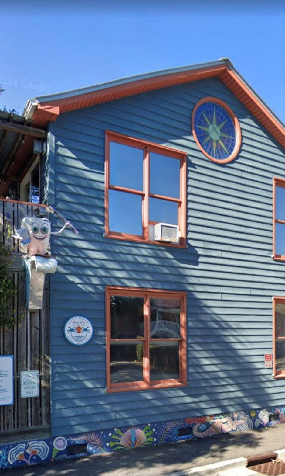 Folly Beach Day Spa bungalow exterior with bright orange door