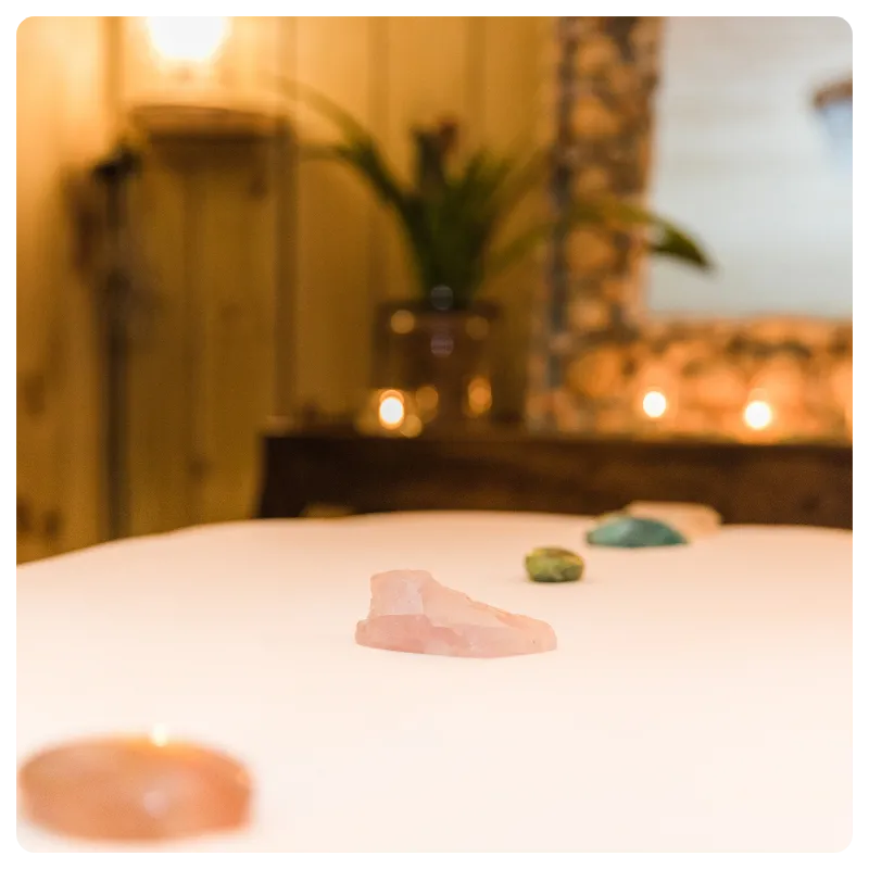 Rose quartz and healing stones arranged on a massage table